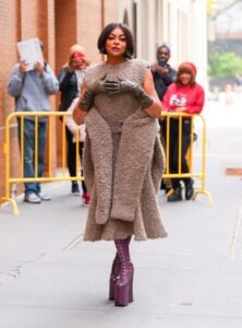 Actress Taraji P. Henson recently made an appearance while strutting around the streets of New York City wearing a furry Marc Jacobs dress and purple, sky-high shoes. Henson, who was adorned by Jason Rembert, was also spotted sporting black ruched leather gloves and Tym Wallace, with Saisha Beecham's hair and makeup.Henson used the sidewalk as her little catwalk, posing for photos from every angle, needless of any runway. The enormous sherpa dress, which appeared to be made of several pieces stitched together at the waist, was one single piece. In the front of the dress, the sleeves of the connected jacket were left untied, revealing a peek of the built-in belt.
The woolly dress, which was made with comfort in mind, had a high neckline, no sleeves, and a waistline that curled into a subtle mermaid skirt that ended a few inches below her knees. Henson's strappy purple boots, which served as both footwear and stilts as she gracefully moved past the throng, matched her outfit.

Also Read: Elle and Dakota Fanning Show Off Contrasting Spring Styles at Power Stylists Dinner

The dress first appeared at the designer's Vivienne Westwood-inspired "Heroes" fall 2023 runway presentation in New York City. The items in the collection mixed avant-garde fashion with dramatic and abstract designs. Henson's outfit, which was a combination of a frock and a jacket, nicely illustrated this unusual fashion combo.

Henson is renowned for her adventurous sense of style and her knack for personalizing any look. Henson is always prepared to make a statement with her clothing choices, whether she's walking down the red carpet or just taking a stroll through the streets. She is not reluctant to try out vibrant hues, unusual fabrics, and intriguing designs. Her wardrobe selections always showcase her self-assurance and bravery.

Taraji P. Henson is a well-known face for her acting skills and performances in the movies such as "The Curious Case of Benjamin Button" and "Hidden Figures." She has also received multiple nominations for performing as Cookie Lyon on a famous TV show called "Empire."
