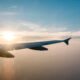 airplane wing and sunset on blue sky