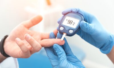 Doctor checking blood sugar level with glucometer